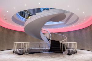 a spiral staircase in a room with a ceiling at Park Inn by Radisson Lübeck in Lübeck