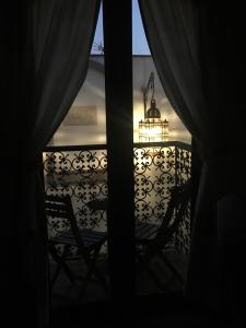 a view from a window of a balcony with a light at Darcilla Guest House in Tarifa