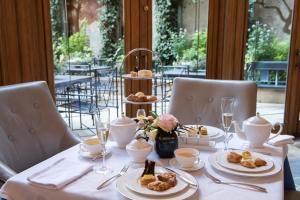 a table with plates of food on top of it at The Rittenhouse Hotel in Philadelphia
