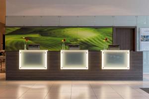 
a wall with a picture of a vase of flowers on it at Park Inn by Radisson Linz in Linz
