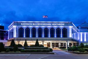 a large building with a clock on the front of it at Radisson Blu Edwardian Heathrow Hotel, London in Hillingdon