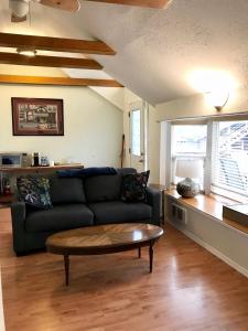 a living room with a couch and a coffee table at The Surf Lodge and Pub in Gabriola