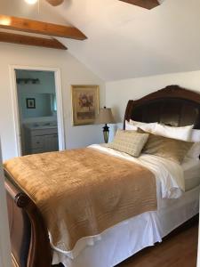 a bedroom with a large bed with a wooden headboard at The Surf Lodge and Pub in Gabriola