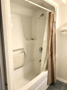 a bathroom with a tub and a shower at The Surf Lodge and Pub in Gabriola