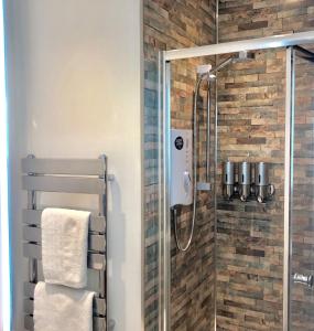 a bathroom with a shower with a glass door at Lundy SeaView Great Sea-views in Westward Ho