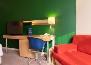 a living room with a couch and a lamp at Park Inn by Radisson in Yekaterinburg