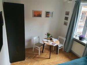 a dining room with a table and chairs in a room at RentOnline Kościelna Apartment Old Town in Warsaw