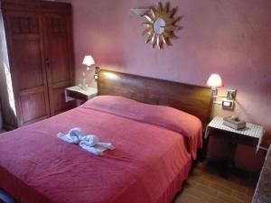 a bedroom with a bed with a towel on it at I Casali del Buontempo in Buggiano