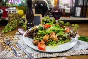 a plate of food with a salad on a table at Gasthaus & Hotel Drei Lilien in Werbach