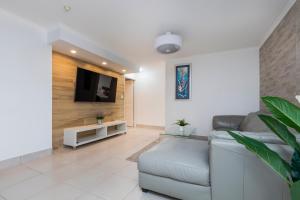 a living room with a couch and a television at Silverton Apartment Resort Surfers Paradise in Gold Coast