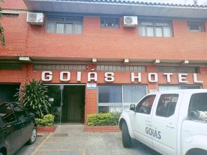 un camion blanc garé devant un hôtel Coles dans l'établissement Goias Hotel, à Goiânia