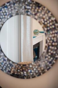 a mirror with a reflection of a room at Springfield guest house in Tain