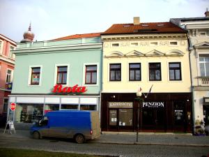 a blue van parked in front of a building at Penzion Aviatik in Čáslav