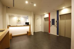 an empty office with a white counter and a desk at Grand Cabin Tenjin Minami in Fukuoka