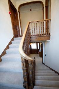 a staircase in a house with a wooden railing at Springfield guest house in Tain