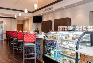 a bakery with a counter with a lot of pastries at Hotel Indigo Chicago - Vernon Hills by IHG in Vernon Hills