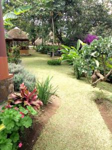 a garden with flowers and a gazebo at Nyore Hillside Retreat in Mbarara