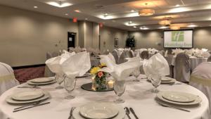 a table with white tablecloths and glasses on it at Holiday Inn North Quail Springs by IHG in Oklahoma City +63 photos