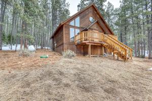 a log cabin in the woods with a staircase at The Chamberlain Chalet in Angel Fire