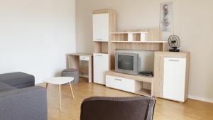 a living room with a couch and a tv at Apartment Amalia in Labin