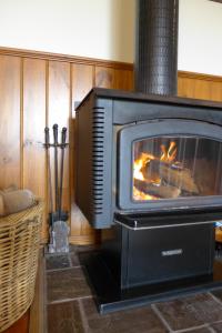 an oven with a fire place in it at Daysy Hill Country Cottages in Port Campbell