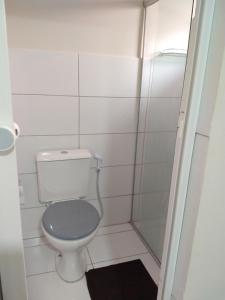 a small bathroom with a toilet and a shower at Palhoça da Colina in Fernando de Noronha +71 photos