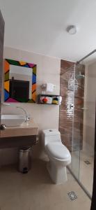 a bathroom with a toilet and a sink and a shower at San Bernardo Hotel in Ríohacha