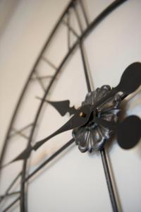 a close up of a clock with scissors on it at Springfield Guesthouse in Tain +24 photos