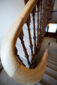 a wooden spiral staircase with a wooden hand rail at Springfield guest house in Tain