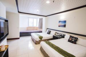 Łóżko lub łóżka w pokoju w obiekcie Kenting Maldives Hotspring Hotel