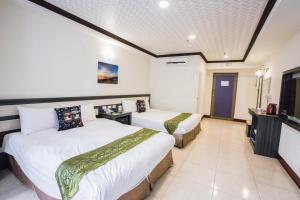 Łóżko lub łóżka w pokoju w obiekcie Kenting Maldives Hotspring Hotel