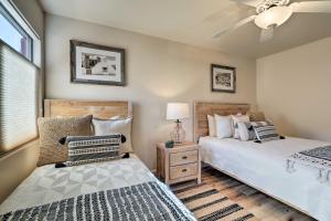 a bedroom with two beds and a ceiling fan at Luxury Sedona Living Remodeled with Red Rock Views! in Sedona