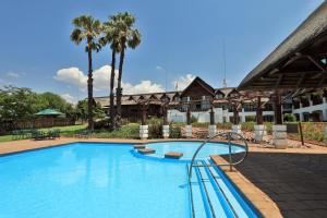 a swimming pool with a slide in a resort at Emerald Resort & Casino in Vanderbijlpark