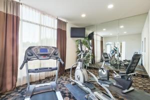 a gym with three exercise bikes in a room at Holiday Inn Temple - Belton, an IHG Hotel in Temple