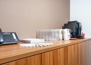 a desk with a phone and a cup on it at Holiday Inn - Vienna - South, an IHG Hotel in Vienna