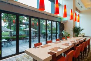 a long dining room with a long table and chairs at Holiday Inn Shanghai Pudong Kangqiao, an IHG Hotel in Shanghai