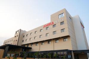 a building with an ana hotel sign on it at Amika Hotel,Madurai - Near Airport in Madurai