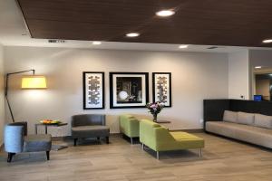 a waiting room with chairs and a couch and a table at Holiday Inn Express Hotel & Suites Albany, an IHG Hotel in Albany