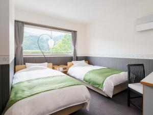 Letto o letti in una camera di Amano Hashidate Hotel
