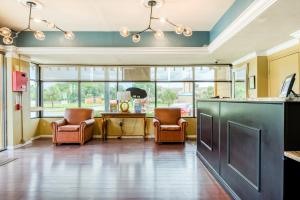 a kitchen with two chairs and a table in a room at Hotel Belair Orlando Near Florida Mall in Orlando