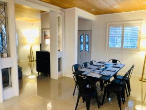 a dining room with a table and chairs at Bellbird House in Cessnock