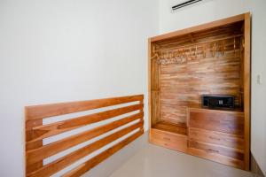 乌鲁瓦图WIRA Homestay & Spa的客房内的步入式衣柜和木镶板