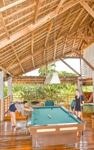 a man and a woman playing a game of pool at Chief Mau Moalboal Cebu in Moalboal