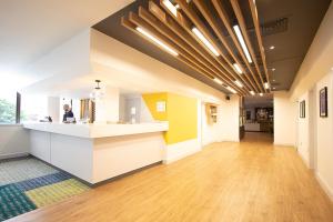 an office lobby with a reception counter and wood floors at Holiday Inn Preston, an IHG Hotel in Preston