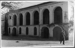 an old photo of a man standing in front of a building at Agriturismo La Filanda in Manerba del Garda