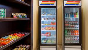 two refrigerators in a store with food and drinks at Holiday Inn Oklahoma City Airport by IHG in Oklahoma City