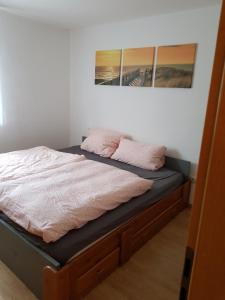 Una cama con dos almohadas rosas encima. en 2 Zimmer Wohnung mit Balkon - Nähe Messe, en Haar