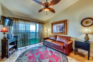 a living room with a leather couch and a television at Bayview Beach Escape in Pensacola Beach