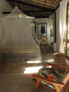 a room with a tent and a bench and a table at The Lion Cottage- Charming Studios in Santo André