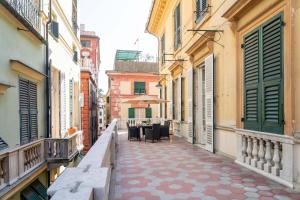an alley with tables and chairs on a city street at Family Apartments Angeli in Genoa